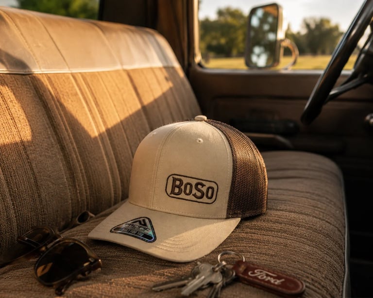 BOSO trucker cap on truck seat with sunglasses and keys in sunlight