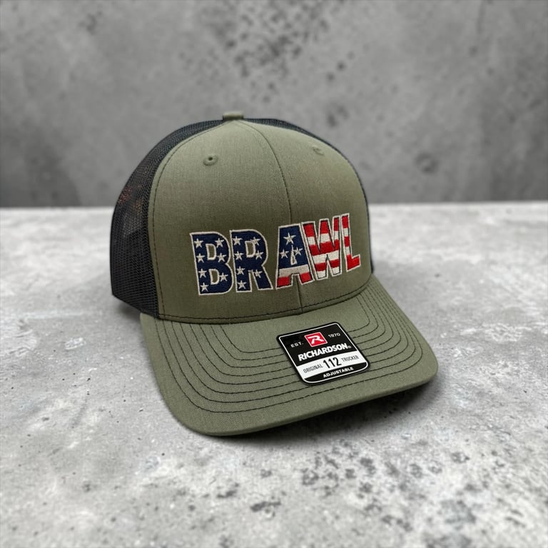 Olive and black mesh trucker cap with BRAVE text in red, white, and blue American flag design on front